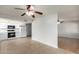 Well-lit kitchen area with white cabinets and appliances adjacent to a dining space at 13148 N 21St Ave, Phoenix, AZ 85029