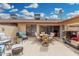 Outdoor patio with a golf cart, lounge area, dining table, and desert landscaping, ideal for leisure at 13630 W Aleppo Dr, Sun City West, AZ 85375