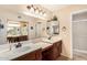 Well-lit bathroom with dual sinks, a vanity area, and ample mirror space at 13630 W Aleppo Dr, Sun City West, AZ 85375
