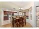 Cozy dining area with wood table, chandelier, and kitchen access, creating a welcoming atmosphere at 13630 W Aleppo Dr, Sun City West, AZ 85375