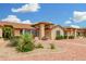 Charming single-story home showcasing beautiful landscaping with vibrant bushes and desert plants at 13630 W Aleppo Dr, Sun City West, AZ 85375
