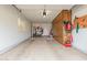Spacious garage with ample storage cabinets, tools, and a clean, painted floor at 13630 W Aleppo Dr, Sun City West, AZ 85375