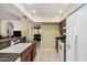Well-lit kitchen with ample counter space, white appliances, and convenient access to adjacent rooms at 13630 W Aleppo Dr, Sun City West, AZ 85375