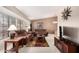 Inviting living room featuring plush brown sofas, natural light, and stylish decor at 13630 W Aleppo Dr, Sun City West, AZ 85375