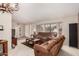 Cozy living room featuring plush sofas, natural light from a bay window, and neutral decor at 13630 W Aleppo Dr, Sun City West, AZ 85375