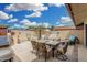 Inviting outdoor patio with comfortable seating, a dining table, and a lush palm tree, perfect for relaxation at 13630 W Aleppo Dr, Sun City West, AZ 85375