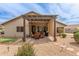Comfortable outdoor space with covered patio, furniture, grill, and landscaped backyard for relaxing and entertaining at 14374 W Amelia Ave, Goodyear, AZ 85395