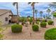 Expansive backyard featuring manicured shrubs, putting green, patio, and desert landscaping at 14374 W Amelia Ave, Goodyear, AZ 85395