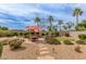 Landscaped backyard featuring a putting green, dining area, water feature, and desert plants at 14374 W Amelia Ave, Goodyear, AZ 85395