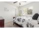 Bright bedroom with a ceiling fan and window with shutters, complete with a cozy bed and stylish decor at 14374 W Amelia Ave, Goodyear, AZ 85395