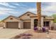 Charming single-story home features a three-car garage, desert landscaping, and a welcoming entrance at 14374 W Amelia Ave, Goodyear, AZ 85395