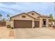 Beautiful single-Gathering home with a three-car garage and desert landscaping at 14374 W Amelia Ave, Goodyear, AZ 85395
