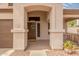Charming front entryway with a decorative door and well-maintained landscaping at 14374 W Amelia Ave, Goodyear, AZ 85395