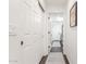 Hallway featuring a sliding door and view into the laundry room with washer and dryer at 14374 W Amelia Ave, Goodyear, AZ 85395
