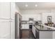 Well-equipped kitchen with stainless appliances, white cabinetry, and a breakfast bar perfect for casual dining at 14374 W Amelia Ave, Goodyear, AZ 85395