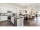 Eat-in kitchen features stainless appliances, center island and breakfast table at 14374 W Amelia Ave, Goodyear, AZ 85395