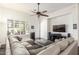 Inviting living room area with a comfortable sectional couch and ceiling fan at 14374 W Amelia Ave, Goodyear, AZ 85395