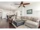 Open-concept living room that flows into the kitchen and dining area at 14374 W Amelia Ave, Goodyear, AZ 85395