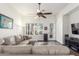 Cozy living room with a ceiling fan and large windows providing natural light at 14374 W Amelia Ave, Goodyear, AZ 85395