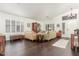 Open-concept living room featuring hardwood floors and plantation shutters at 14374 W Amelia Ave, Goodyear, AZ 85395