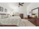 Cozy main bedroom with ceiling fan, plantation shutters and ensuite bath at 14374 W Amelia Ave, Goodyear, AZ 85395