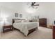 Comfortable bedroom featuring a ceiling fan, plantation shutters and neutral decor at 14374 W Amelia Ave, Goodyear, AZ 85395