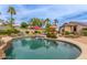 Resort-style pool features a water feature, lush landscaping, a mini-golf, and patio seating for outdoor entertainment at 14374 W Amelia Ave, Goodyear, AZ 85395