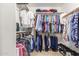 Spacious walk-in closet with ample hanging space, shelving, and organized storage solutions at 14374 W Amelia Ave, Goodyear, AZ 85395