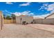 Spacious backyard featuring gravel, brick accents, grill, and access door under a bright blue sky at 1535 N Horne -- # 35, Mesa, AZ 85203