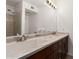 Bathroom featuring dual sinks with dark wood cabinets and large mirror at 1535 N Horne -- # 35, Mesa, AZ 85203