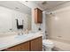 Cozy bathroom featuring wood cabinet, mirror, and shower over bathtub at 1535 N Horne -- # 35, Mesa, AZ 85203