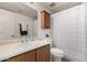 Cozy bathroom featuring wood cabinet, mirror, and shower over bathtub at 1535 N Horne -- # 35, Mesa, AZ 85203