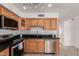 Traditional kitchen with oak cabinets, black countertops, and stainless steel appliances at 1535 N Horne -- # 35, Mesa, AZ 85203