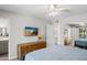 Bright bedroom features ceiling fan, TV, and view to ensuite bathroom and closet at 15430 N 51St Pl, Scottsdale, AZ 85254