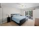 Bedroom features sliding glass doors to backyard with pool, a ceiling fan, and plush carpet at 15430 N 51St Pl, Scottsdale, AZ 85254