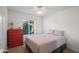 Bright bedroom features a comfortable bed, a red dresser, and a sun-filled window at 15430 N 51St Pl, Scottsdale, AZ 85254