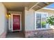 Charming entryway featuring a brick accent wall and a stylish red front door with a decorative glass panel at 15430 N 51St Pl, Scottsdale, AZ 85254