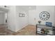 Bright entryway featuring neutral walls, tile floors, and a decorative table with a clock and flowers at 15430 N 51St Pl, Scottsdale, AZ 85254