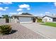 Single story home with a two-car garage, desert landscaping, and a covered entryway at 15430 N 51St Pl, Scottsdale, AZ 85254