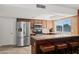 Updated kitchen featuring stainless steel appliances, granite countertops, and a breakfast bar with seating at 15430 N 51St Pl, Scottsdale, AZ 85254