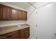 Laundry room features granite countertops and storage cabinets at 15430 N 51St Pl, Scottsdale, AZ 85254