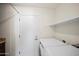 Laundry room features modern washer and dryer and built in shelving at 15430 N 51St Pl, Scottsdale, AZ 85254