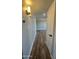 Hallway featuring durable and stylish wood flooring, leading to other areas of the home at 1615 W Michelle Dr, Phoenix, AZ 85023