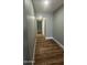 Hallway featuring durable wood flooring and a closet/storage area at 1615 W Michelle Dr, Phoenix, AZ 85023