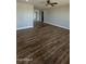 Spacious living room with abundant natural light, a ceiling fan, and attractive wood flooring at 1615 W Michelle Dr, Phoenix, AZ 85023