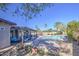 Relaxing backyard with a covered patio, sparkling pool, and lush landscaping for outdoor enjoyment at 1853 W Estrella Dr, Chandler, AZ 85224