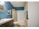 Well-lit bathroom with a shower-tub combo and a dark-stained vanity at 1853 W Estrella Dr, Chandler, AZ 85224