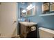 Bathroom featuring a single sink, a white vanity, and blue walls at 1853 W Estrella Dr, Chandler, AZ 85224
