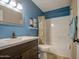 Well-lit bathroom with a shower-tub combo, a dark-stained vanity, and wood-look floors at 1853 W Estrella Dr, Chandler, AZ 85224