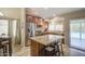 Bright kitchen with stainless steel appliances and a granite-topped island overlooking the pool at 1853 W Estrella Dr, Chandler, AZ 85224